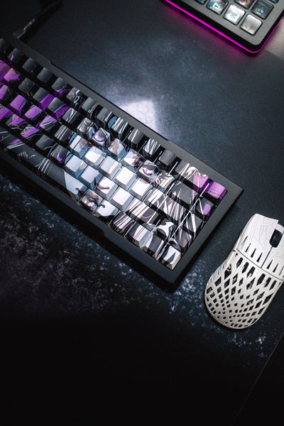 Mechanical keyboard with purple and white keys on a dark surface, accompanied by a mouse.